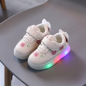 Toddler white sneakers with pink bear patterns and colorful LED light-up soles