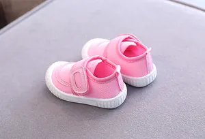 Detailed rear view of pink mesh baby walking shoes with white soft rubber soles