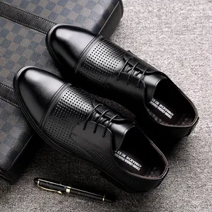 Elegant men's black breathable leather dress shoes with stylish hollow-out design and laces.