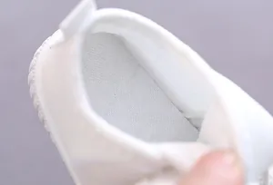 Detailed view of the breathable soft insole and white inner lining of infant walking shoes