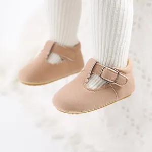 Detail of soft pink baby princess walking shoes with scallop edges and buckle strap