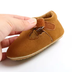 Close-up of brown suede baby princess shoe showing Velcro strap and rubber sole detail