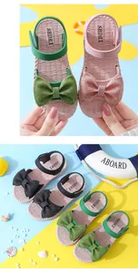 Detailed view of girls' bow sandals with shimmer finish and comfortable soft soles.
