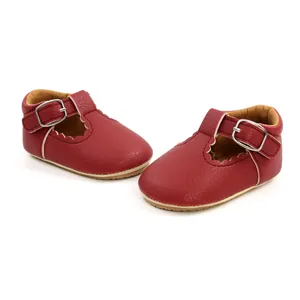 Detailed view of red baby princess walking shoes with scalloped edges and buckle strap.