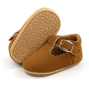 Detail view of brown suede baby shoes showing anti-slip rubber sole and buckle strap.