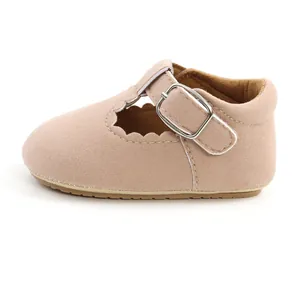 Detailed side view of pink suede infant princess shoes with scalloped edges