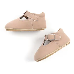 Close-up of baby girl princess walking shoes with scalloped edges and rubber soles