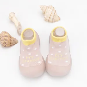 Close-up of breathable knit baby walker shoes with polka dots and soft rubber sole