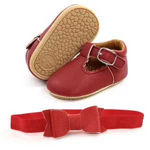 Vista dettagliata di scarpe Mary Jane rosse neonata e fascia con fiocco.