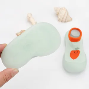 Detail of breathable knit baby sock shoe with non-slip sole and carrot embroidery