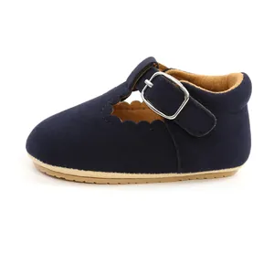 Side view of navy blue suede baby shoe with scalloped edges and buckle strap.