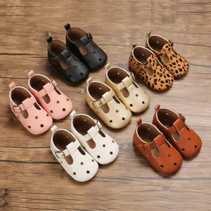 Variety of baby summer sandals with star cutouts and T-straps on a rustic wood background