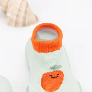 Detailed close-up of breathable knit baby walking sock shoe with cute carrot pattern