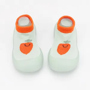 Top view of breathable baby sock shoes with cute carrot pattern and soft green soles