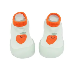 Close-up of breathable baby sock shoes with cute carrot design and soft soles