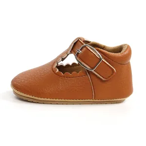 Detailed side view of brown leather baby toddler shoes featuring scalloped edges design.