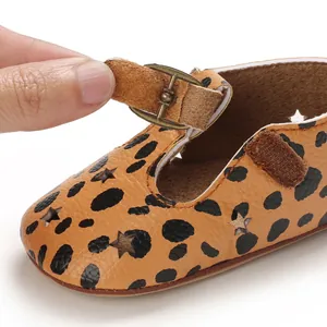 Close-up of leopard print baby walking shoe with Velcro strap and star cutouts.