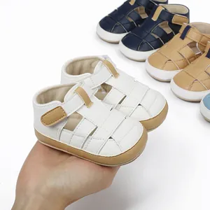 Close-up of white breathable baby summer walking shoes held by hand with other colors