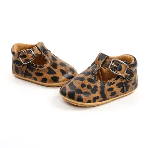 Close-up view of leopard print infant princess toddler shoes with T-strap silver buckle.