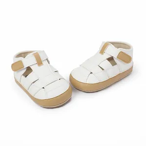 Detailed view of breathable white baby sandals with velcro straps for newborn walkers