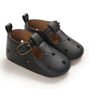 Detailed side view of black PU leather baby shoes with star cutouts and metal buckle