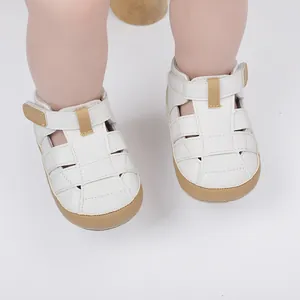 Close-up of white breathable baby sandals with tan soles for infant walkers shoes