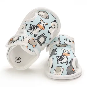 Vista detallada de sandalias para bebé con estampados de cebra y panda en tela azul.