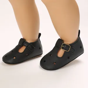 Detailed view of black PU leather baby shoes featuring star cutouts and T-strap buckle