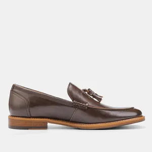 Side profile of dark brown leather tassel loafers with wood grain sole detail
