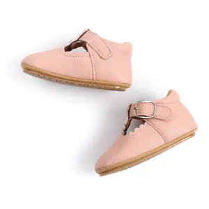 Close-up of pink baby girl Mary Jane walking shoes with rubber sole and scalloped edge
