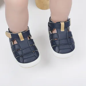 Close-up of navy blue breathable baby walking sandals with soft soles and velcro straps
