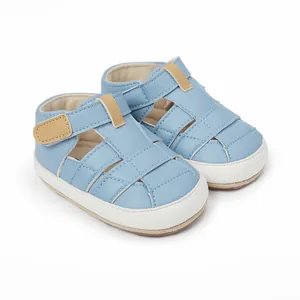 Detailed view of light blue breathable baby sandals with hook and loop soft soles