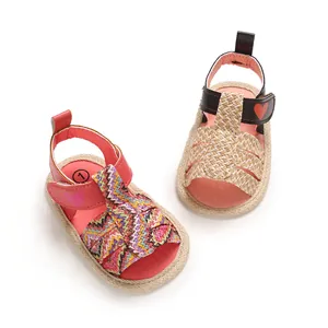 Top view detail of colorful woven baby sandals featuring soft soles and cute heart accents