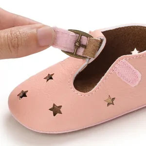 Close-up detail of pink baby pre-walker shoe featuring star cutouts and velcro strap.