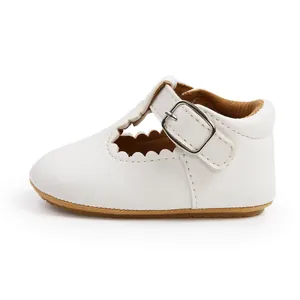 Side profile detail of white baby princess shoe with scalloped edges and silver buckle
