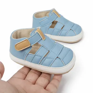 Detailed macro view of light blue breathable baby first walking sandals held in hand