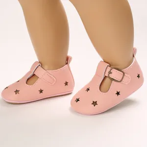 Detailed macro shot of pink PU leather baby pre-walker shoes with star cutouts