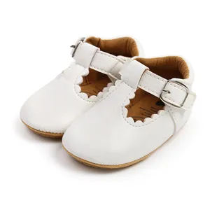 Detailed macro view of white scalloped baby princess walking shoes with rubber sole