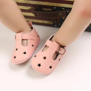 Detailed view of pink soft PU leather baby shoes with star cutouts and T-strap.