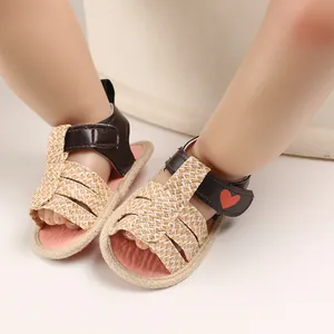 Detail view of baby summer walking sandals with woven straps and heart decoration