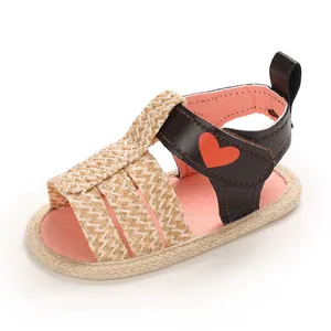Macro view of woven infant sandal with cute red heart pattern on strap