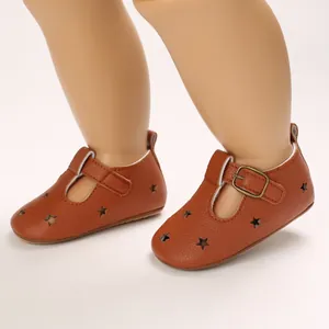 Detailed view of brown PU leather baby pre-walker shoes featuring star cutouts and metal buckles