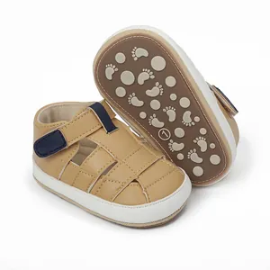 Detailed view of tan baby sandals with non-slip footprint pattern on the brown rubber sole