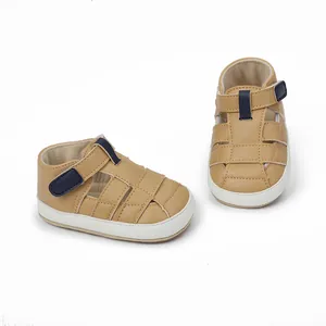 Detail view of breathable brown baby sandals with soft white soles and navy straps