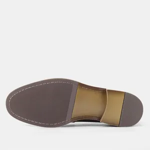 Detail view of men's leather business loafer sole with textured rubber and stitching