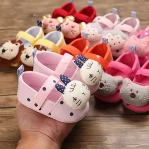Close-up of a pink polka dot baby walking shoe featuring a cute cartoon rabbit design