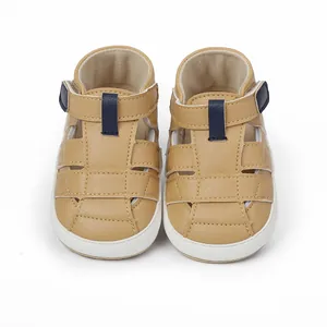 Front view of breathable tan baby walking sandals with soft white soles and blue accents