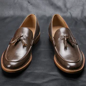 Detail view of brown leather men's loafers featuring classic tassels and wood-grain soles