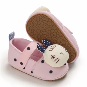 Close-up of pink baby walking shoes with cute rabbit detail and non-slip rubber sole.