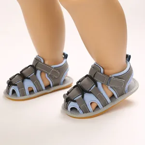 Dettaglio ravvicinato di sandali per neonati blu e grigi con suole morbide e velcro